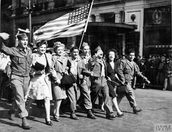 On hearing on the radio of the Japanese offer to surrender on 10 August 1945, American soldiers and English girls parade the &quot;Stars and Stripes&quot; past the famous Criterion restaurant in Piccadilly Circus, London.