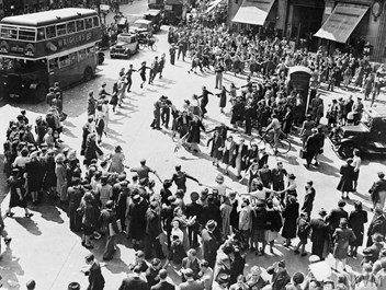 Crowds dancing in Oxford Circus, London on VJ Day.