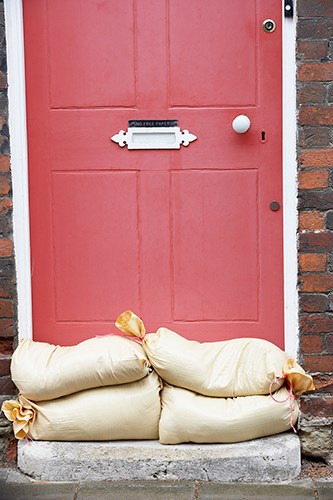 Sandbags placed in front of a house door.