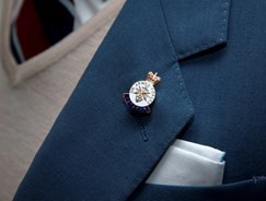 Close-up of a medal being worn on a jacket lapel
