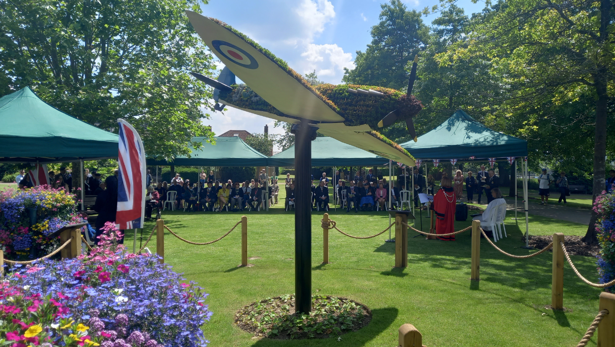 Group gathered in memorial park and spitfire 