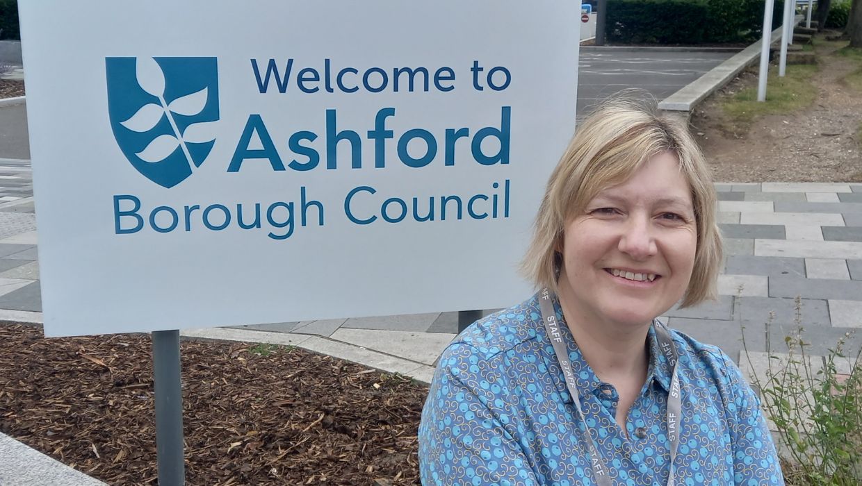 Jo Fox outside the Ashford Borough Council sign by International House