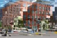 Connect 38 building with vehicles queuing at traffic lights in front