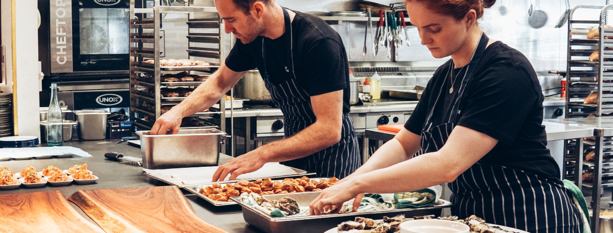 Male and female chef working in a kitchen