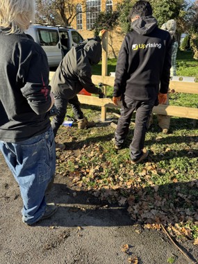 Members of the Uprising Youth organisation installing a new fence