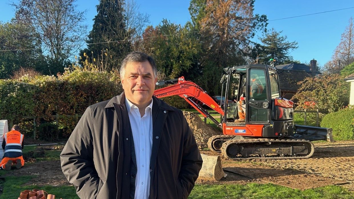 SEC Director Bill Hicks at the installation of the first septic tank