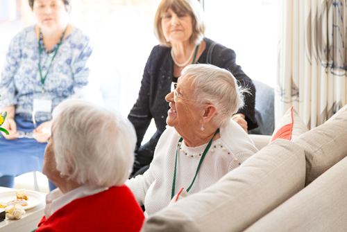 sheltered housing residents talking together on a sofa