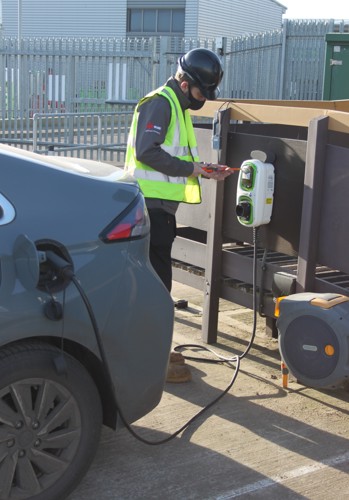 ABC Electrical Services staff member working at an electrical car charging point