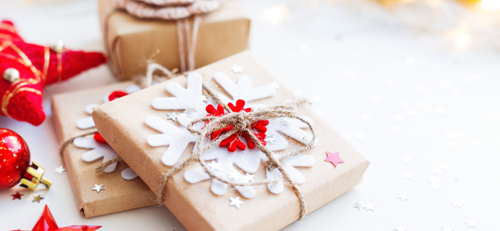 presents wrapped in brown paper with snowflake decoration tied up with string