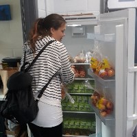 Woman using the community fridge