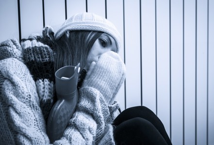 A picture of a girl warming herself up in a cold home