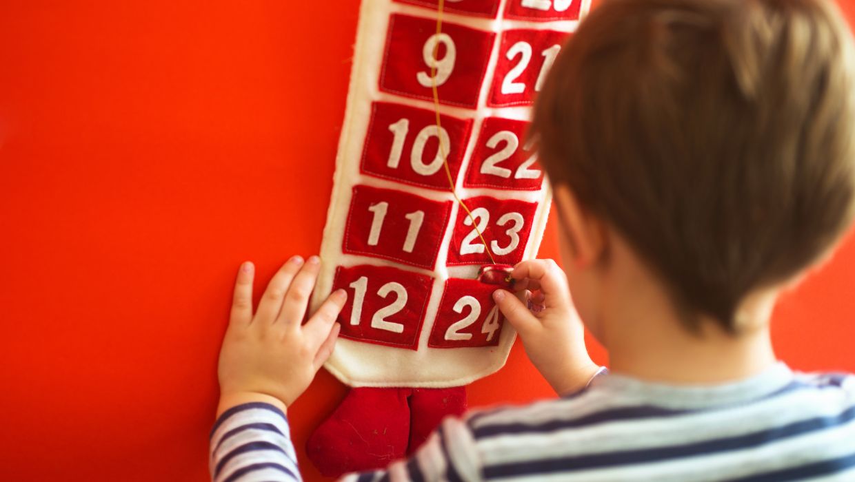 Child opening an advent calendar 