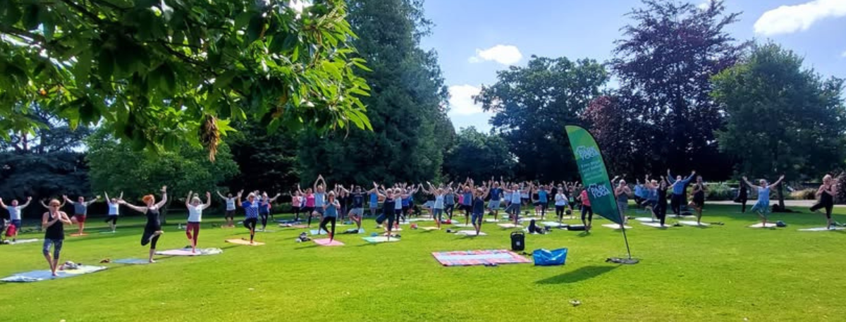 People doing yoga in a park