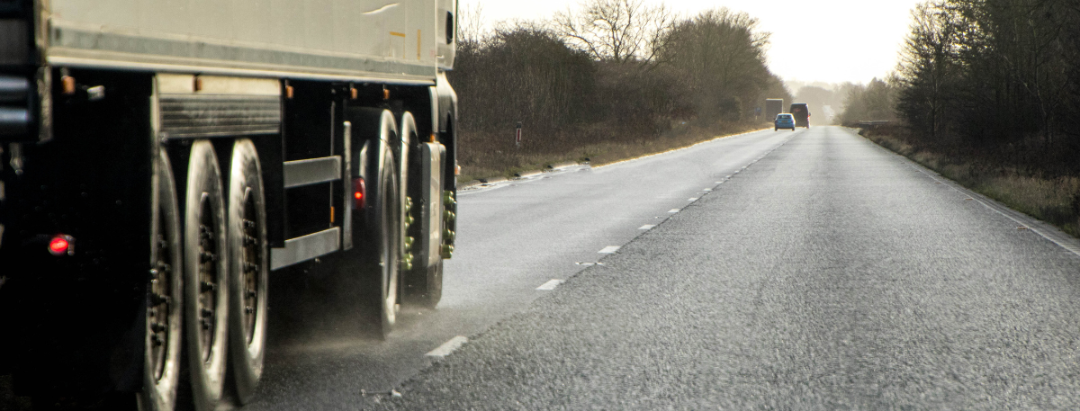 heavy goods vehicle driving on a wet road