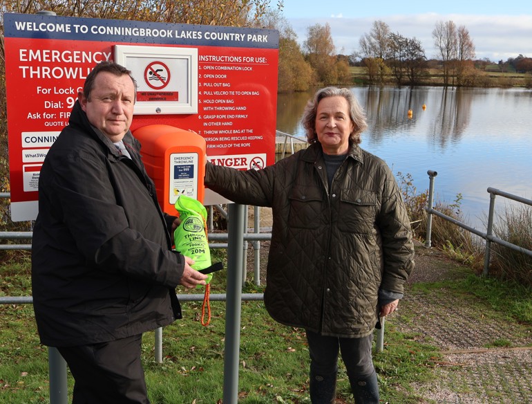 Cllr Kate Walder at one of the Conningbrook Lakes water safety stations with James Laidlaw, Aspire & Parks Portfolio Operations Manager