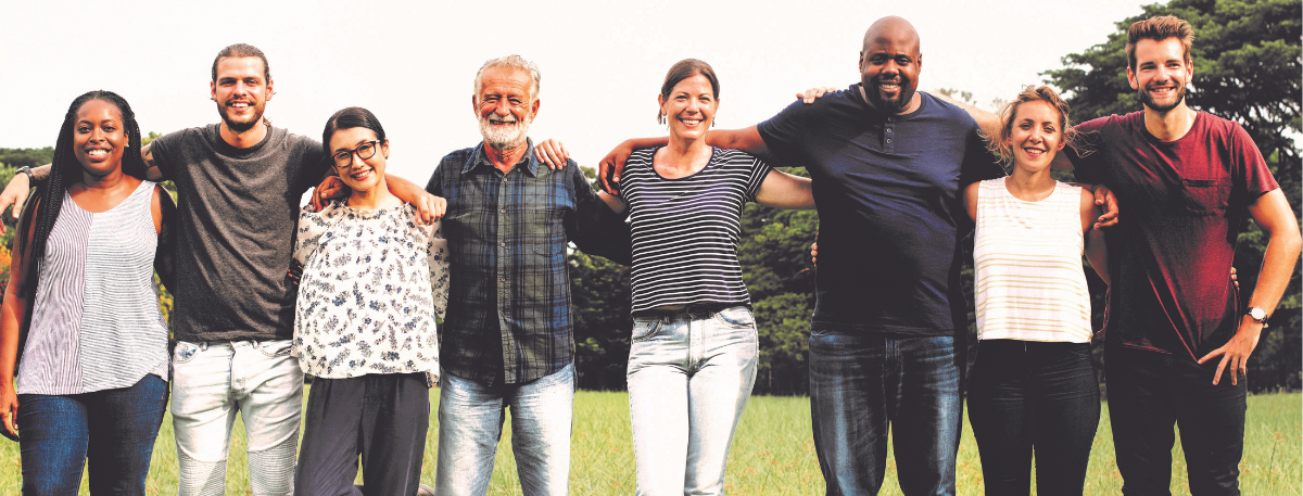 group of people hugging together in a field