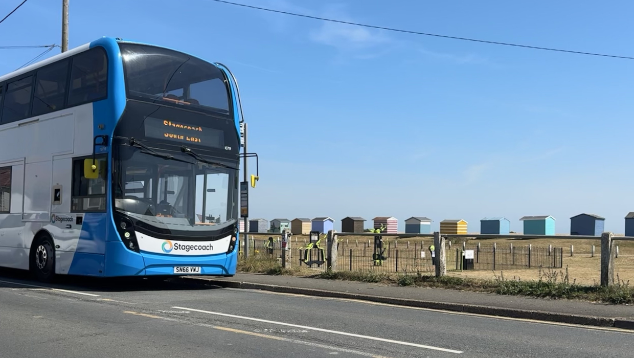 Stagecoach driving past the sea