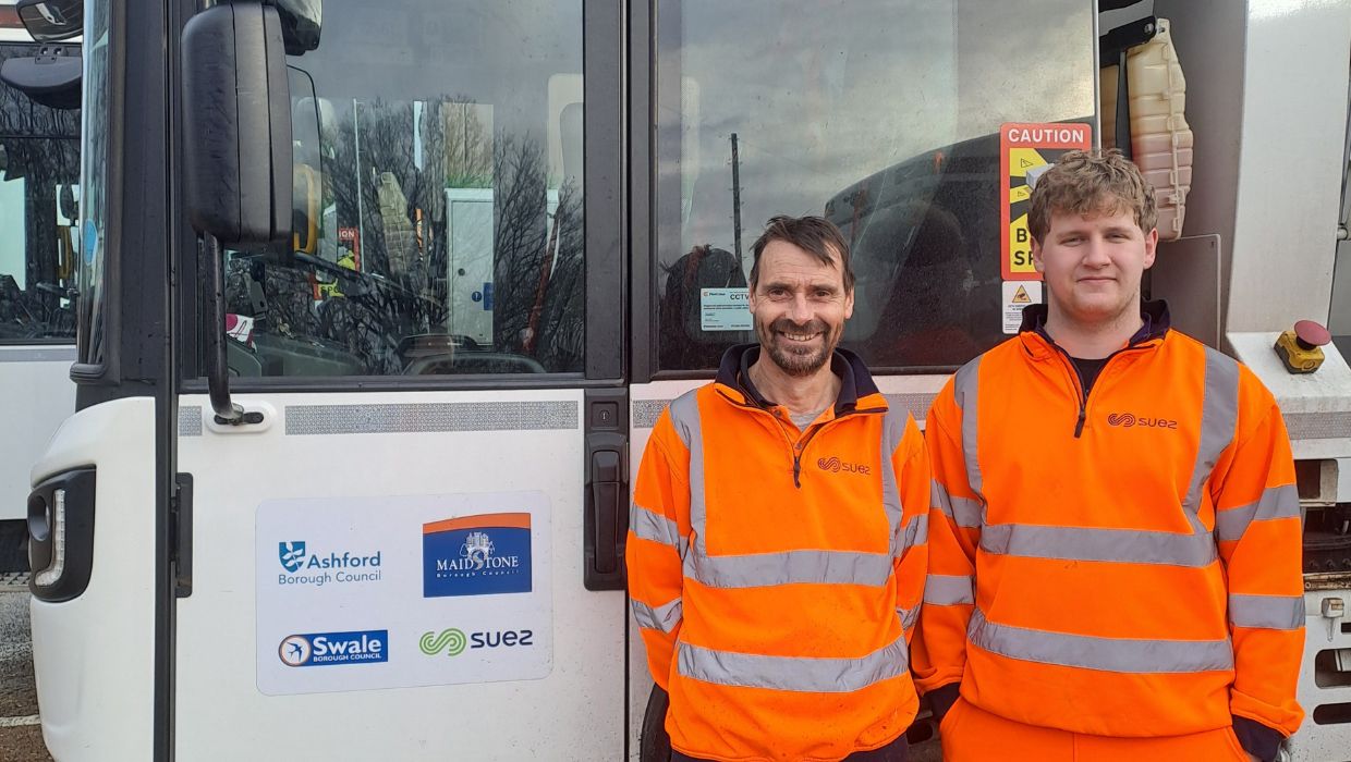 A picture of Dale Shaw and Joshua Foster-Naisbit standing in front of a bin lorry featuring logos of Ashford Borough Council, Maidstone Borough Council, Swale Borough Council and SUEZ