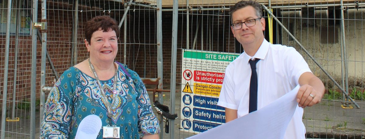 Bill Barrett and Sharon Williams, the council’s Assistant Director of Housing, at Court Wurtin studying plans for the ongoing refurbishment