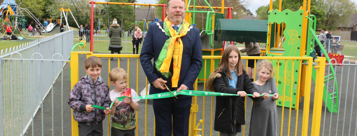 The Mayor of Ashford Cllr Callum Knowles officially opens Hunter Avenue play area in South Willesborough, along with several children