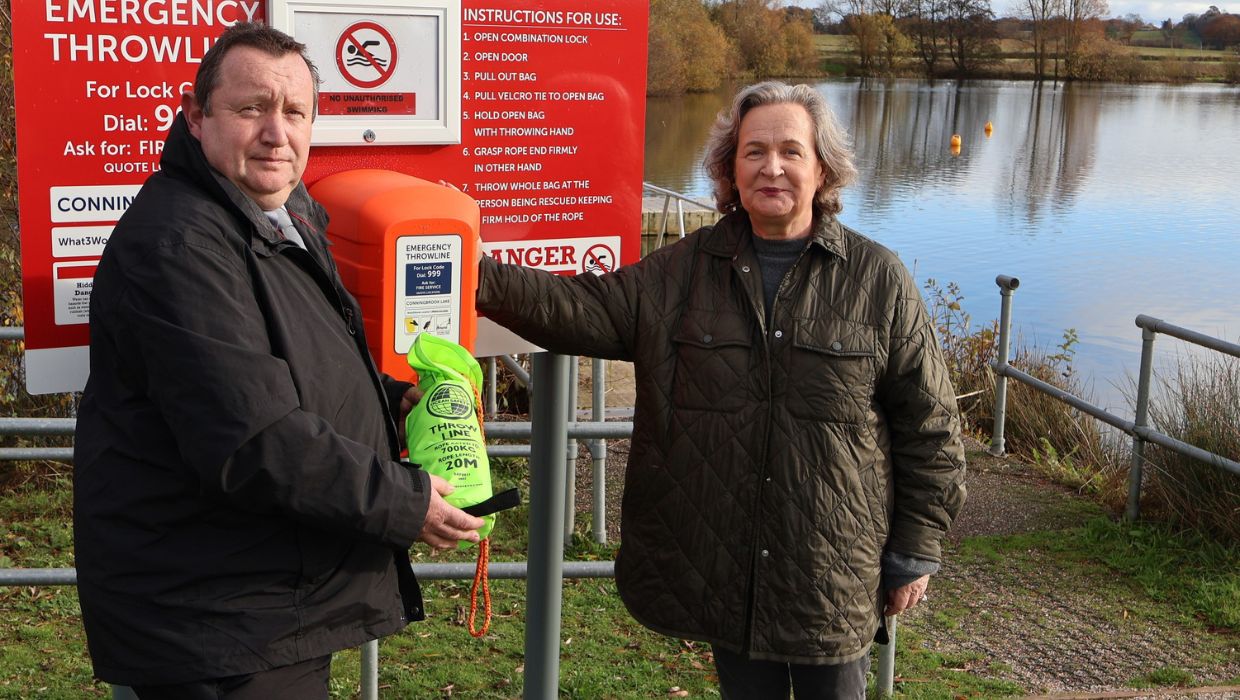 Cllr Kate Walder at one of the Conningbrook Lakes water safety stations with James Laidlaw, Aspire & Parks Portfolio Operations Manager