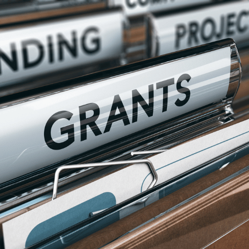 Image entitled A filing cabinet with a prominent divider with the word Grants on it.