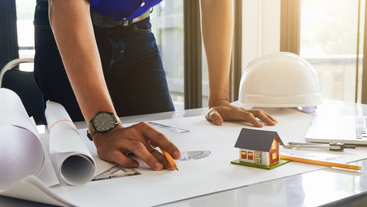 Person looking at planning development plans tile