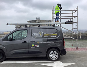 Image entitled ABC Electrical Services Vehicle With Electrician In The Background