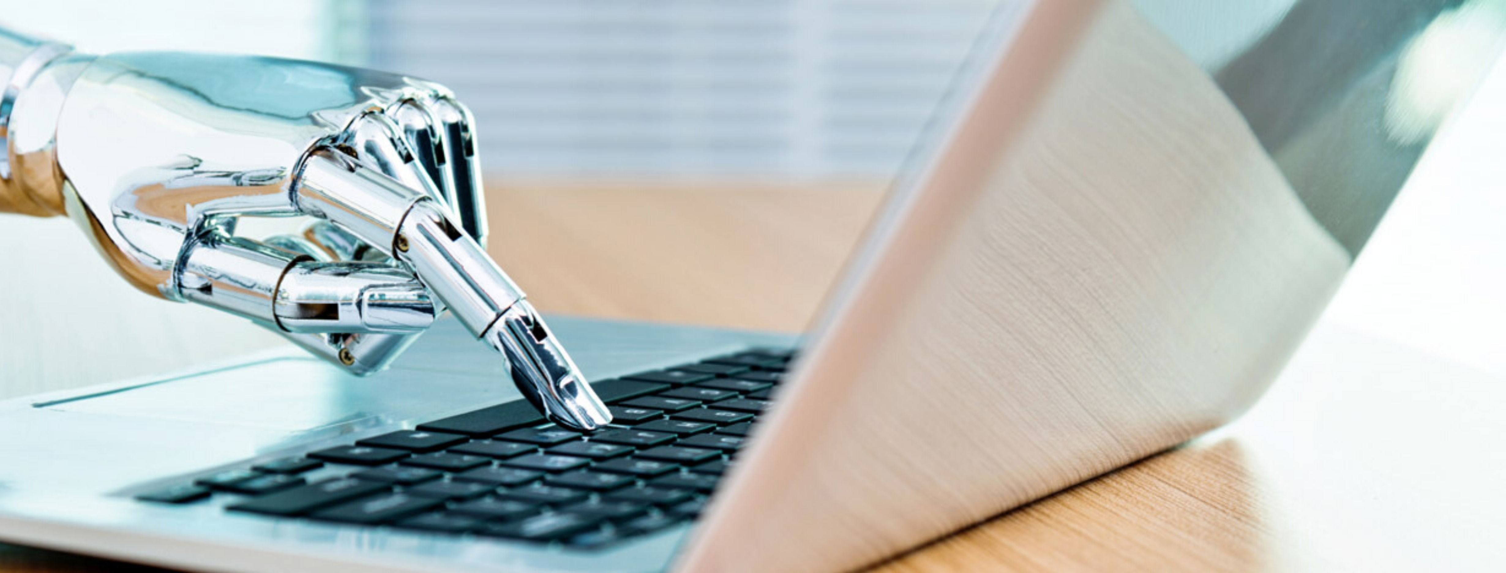 robot pressing a key on a laptop