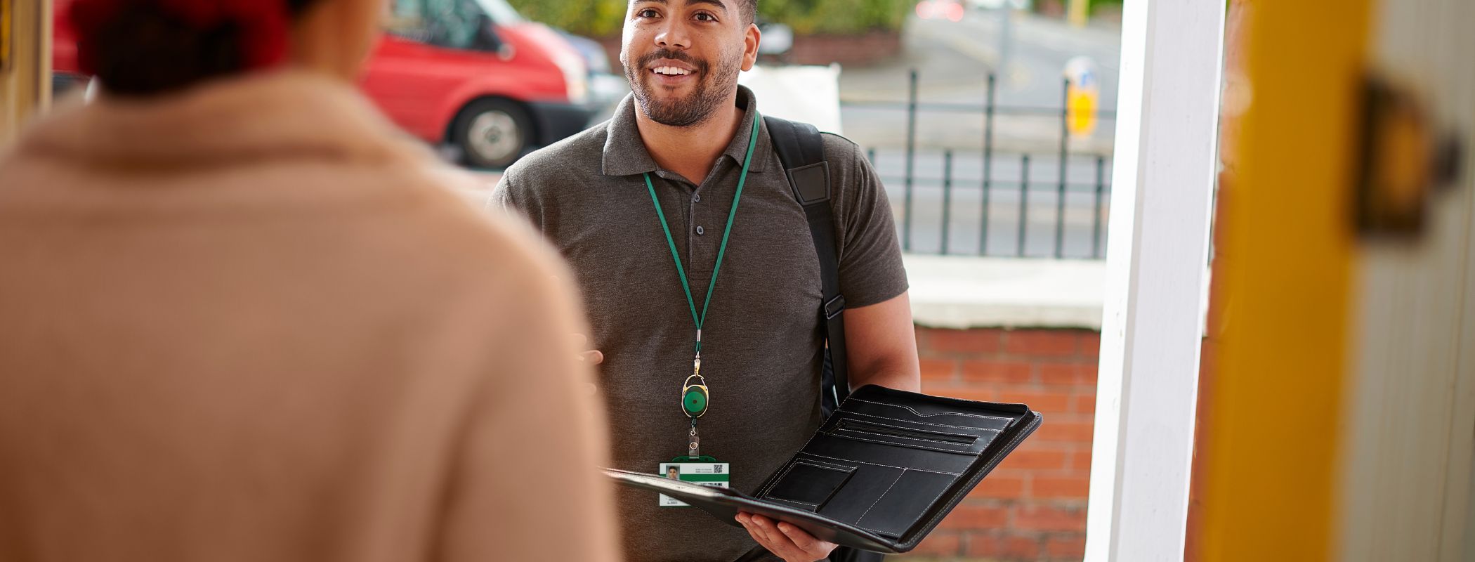 Woman greeting a man at her front door