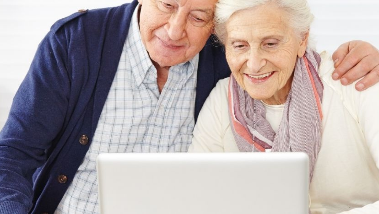 Elderly couple looking at a laptop screen tile