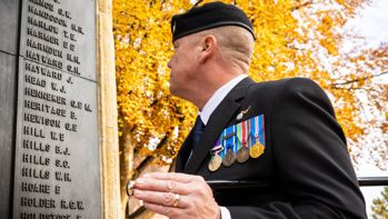 A veteran in Ashford looking at the War Memorial at the Memorial Gardens