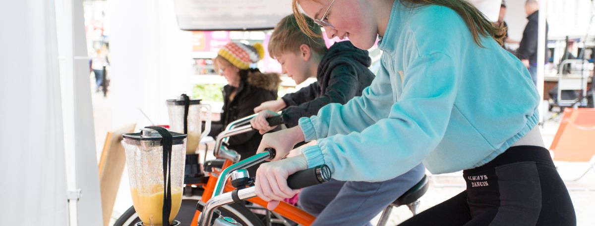 Person on a bike powering a smoothie
