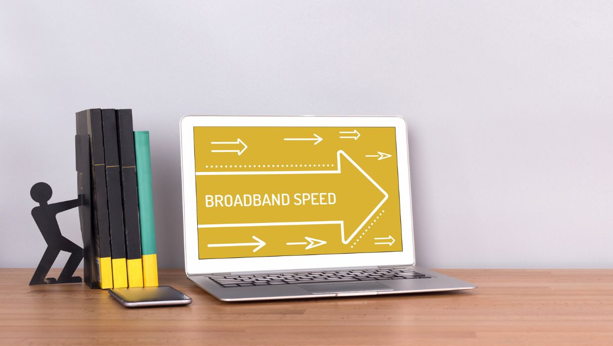 Laptop saying broadband with arrows showing it's faster 