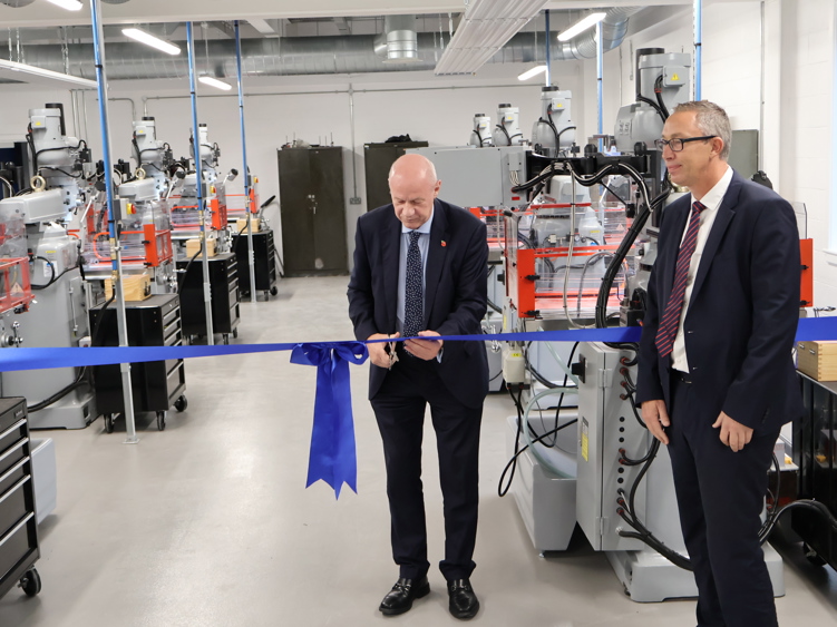 Damian Green MP cuts the ribbon watched by EKC CEO Graham Razey