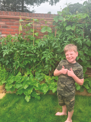 Under-14 winner Joshua Austin in his garden