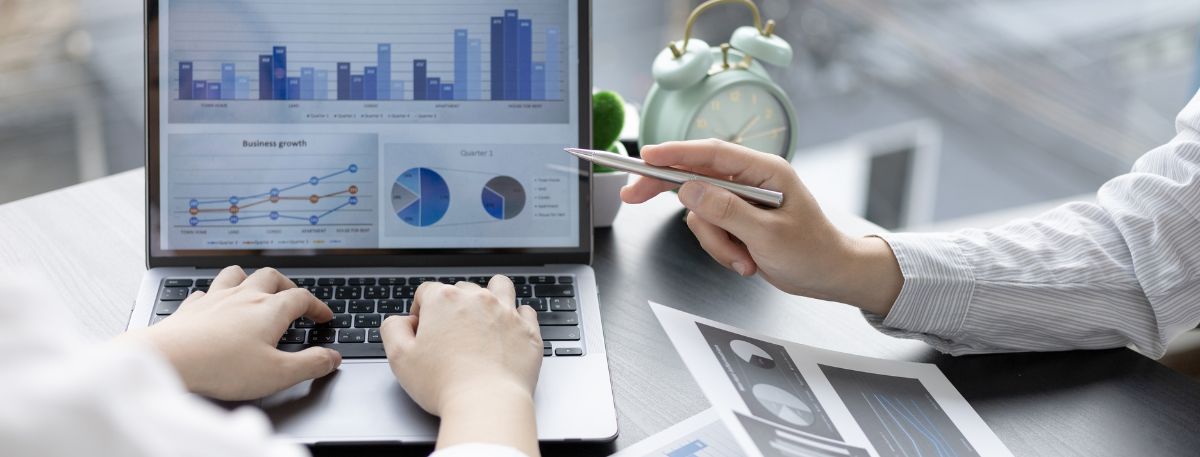 Two people looking at a computer screen that says Business Growth