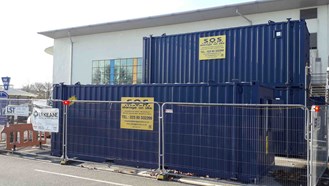 Construction containers placed in front of the Stour Centre