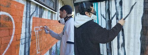 Artists working on the mural in Victoria Park